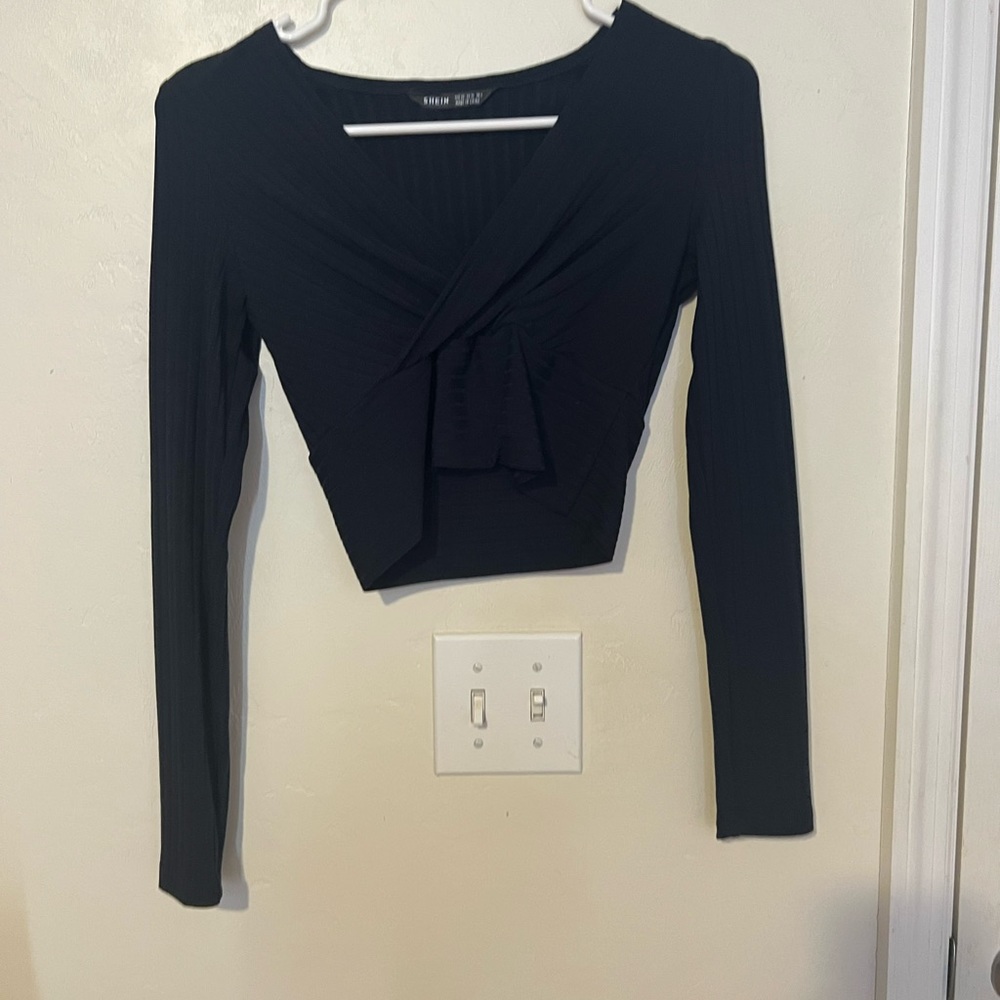 A cropped long sleeve shirt. Dark blue